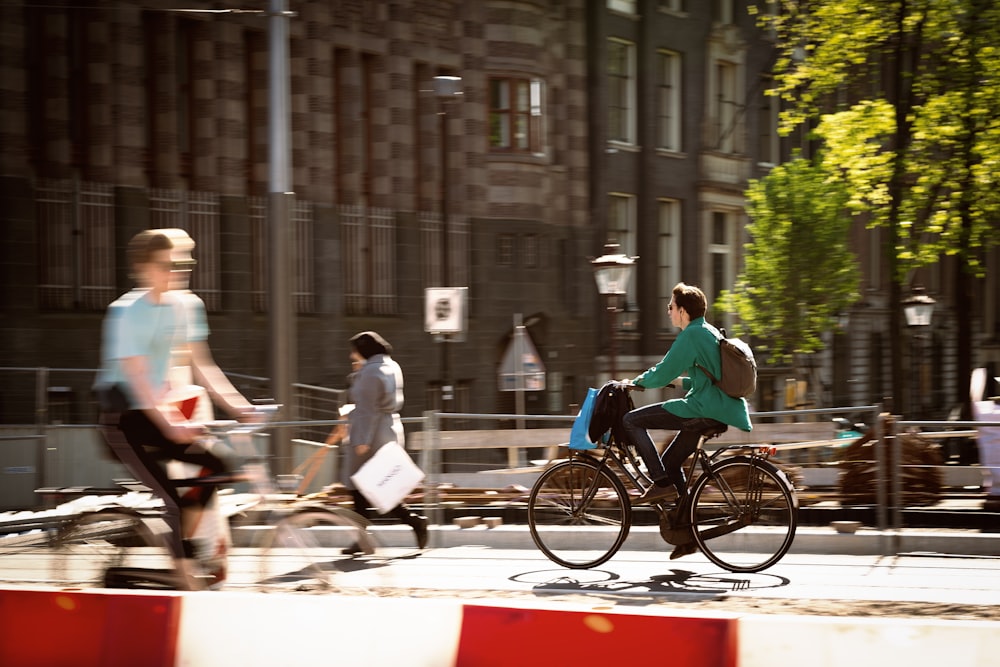 people riding bicycles on street during daytime