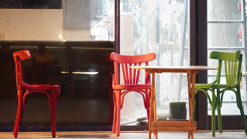 red plastic chair beside glass window