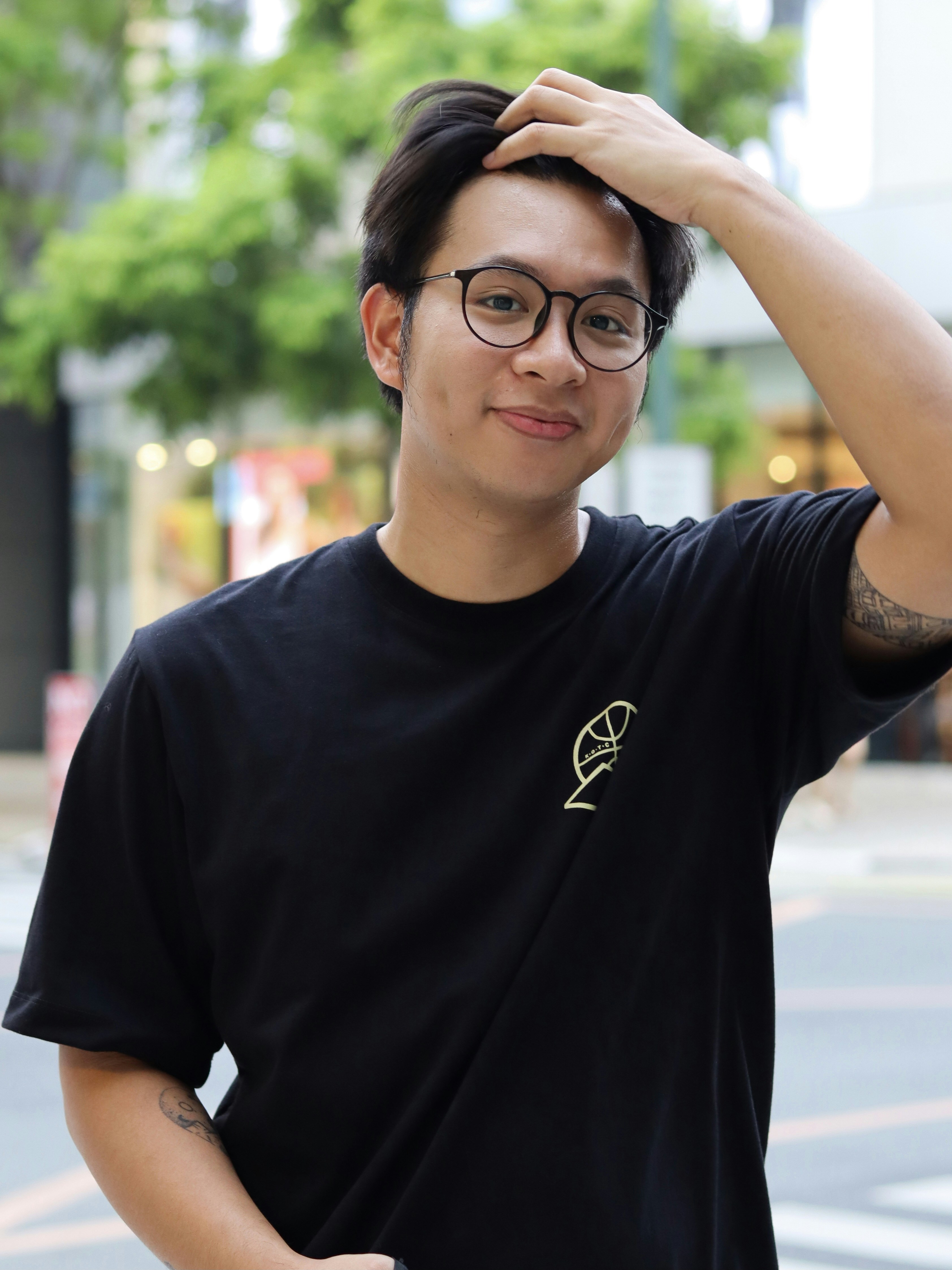 man in black crew neck t-shirt wearing black framed eyeglasses