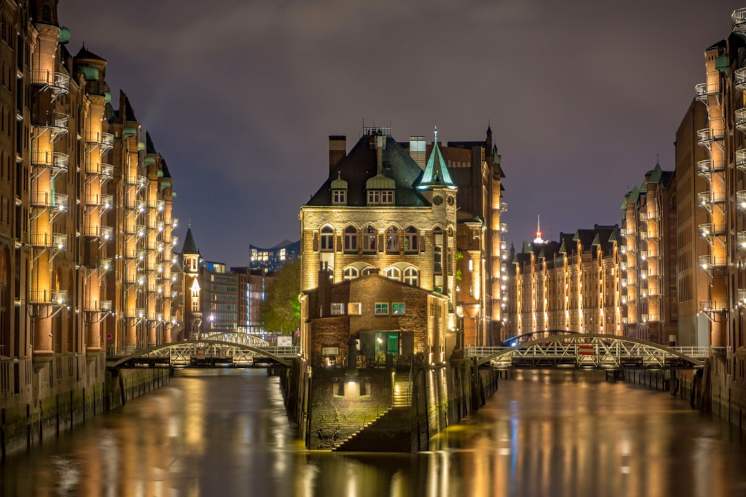 brown concrete building near river during night time