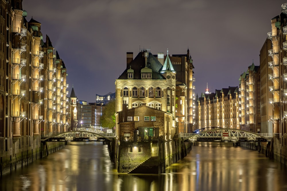 brown concrete building near river during night time