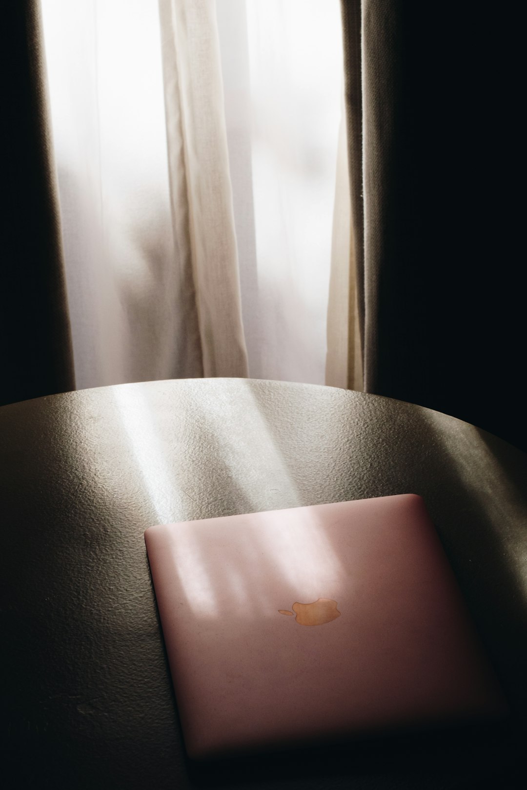 silver macbook on black leather chair