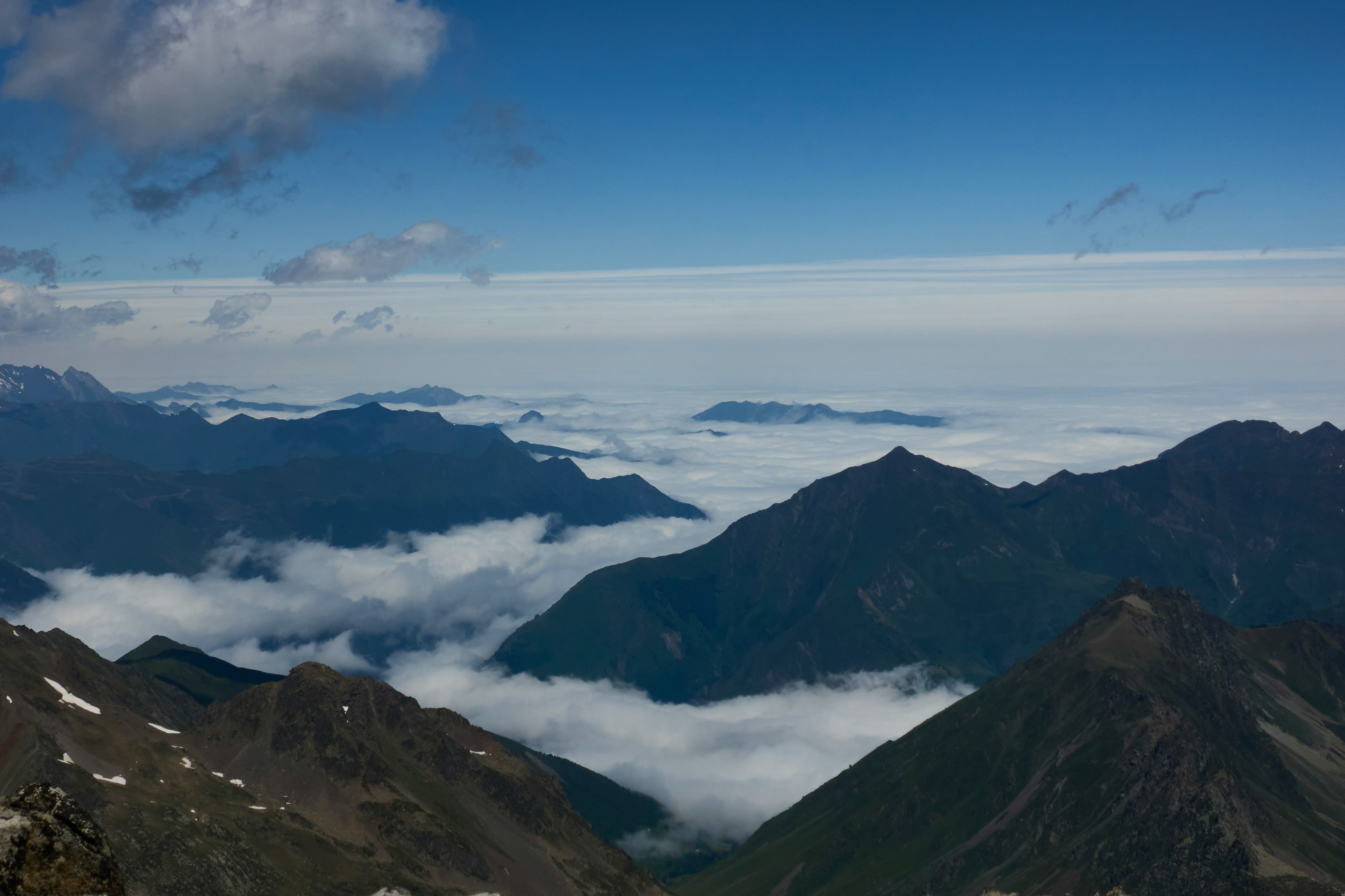 aerial view of mountains under blue sky during daytime