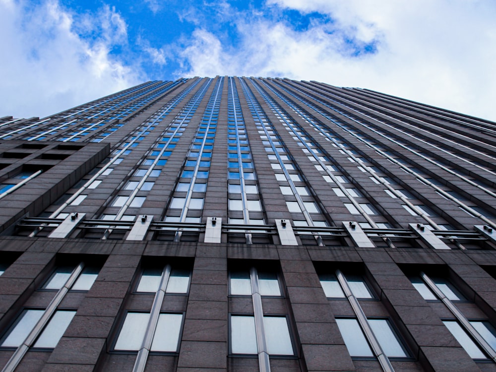 low angle photography of high rise building under blue sky during daytime