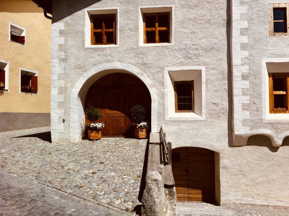 a white building with two windows and a door