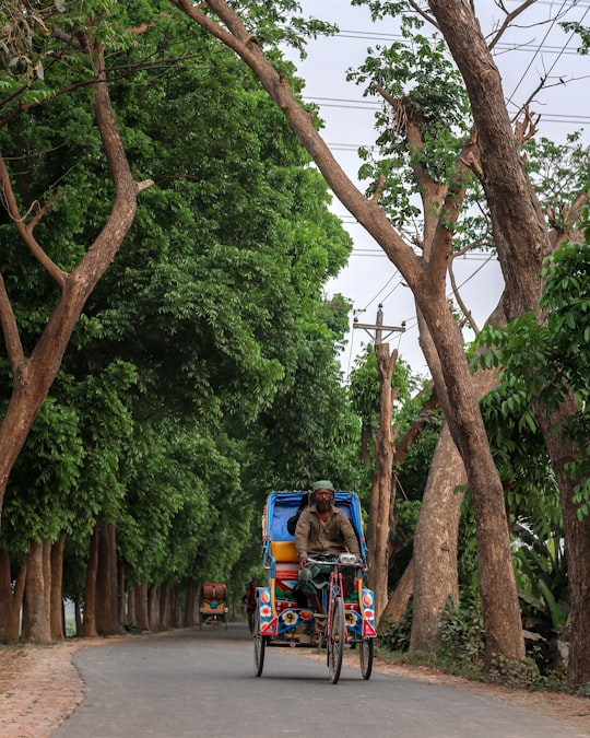 man in blue jacket riding on red and black motorcycle during daytime in Munshiganj Bangladesh