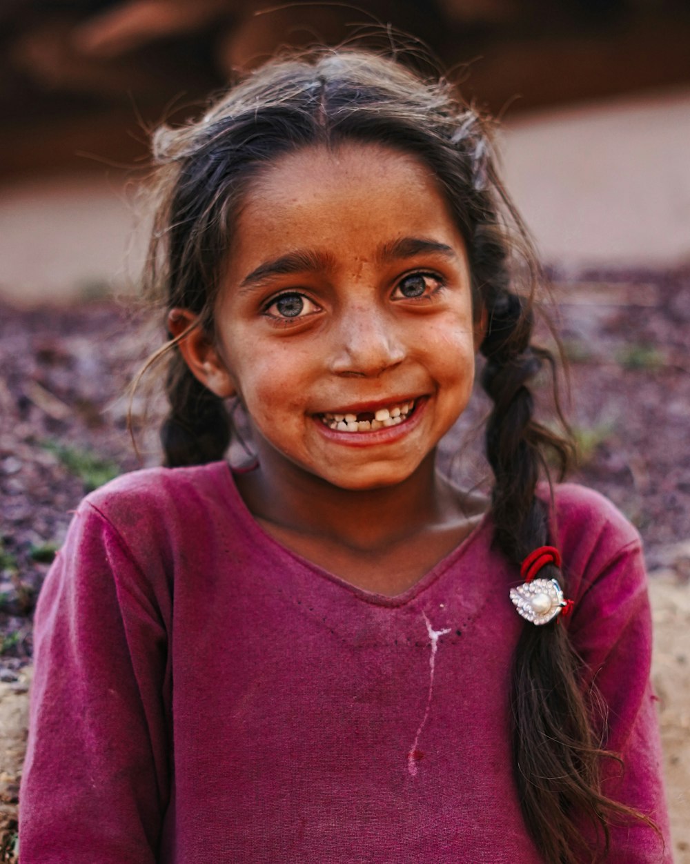 woman in red crew neck shirt smiling