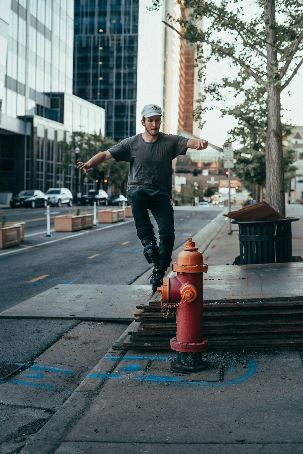 man in black jacket and blue denim jeans jumping on brown wooden bench during daytime