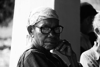man in black framed eyeglasses and black jacket