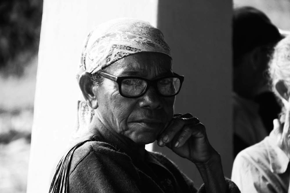 man in black framed eyeglasses and black jacket