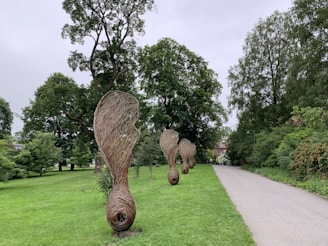 Outdoor installation featuring large-scale sculptures amid lush greenery