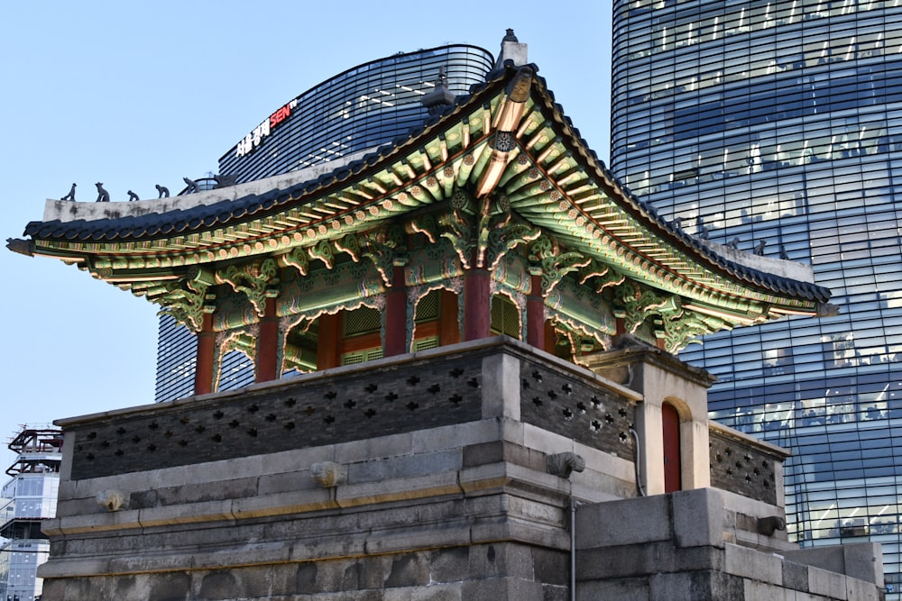 brown and green concrete building under blue sky during daytime