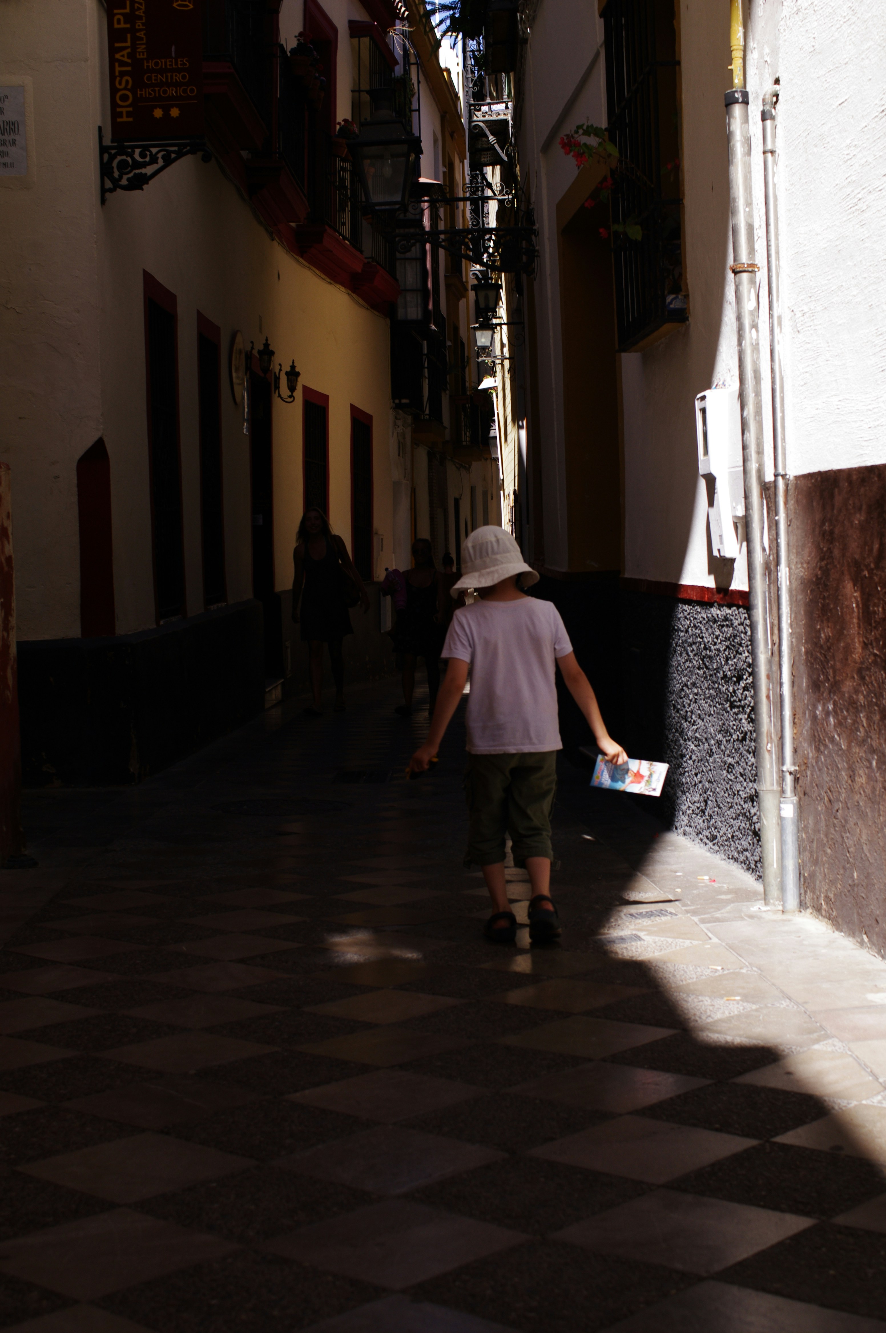woman in white dress walking on sidewalk during daytime