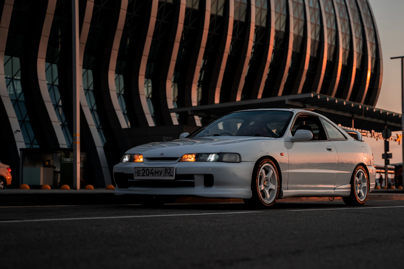 White sports coupe parked on a road