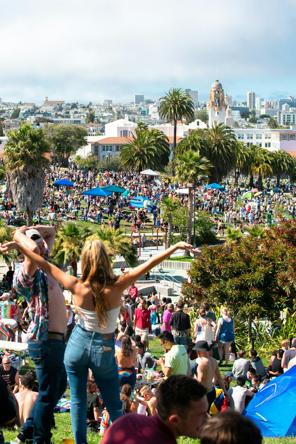 woman in blue denim shorts raising her hands