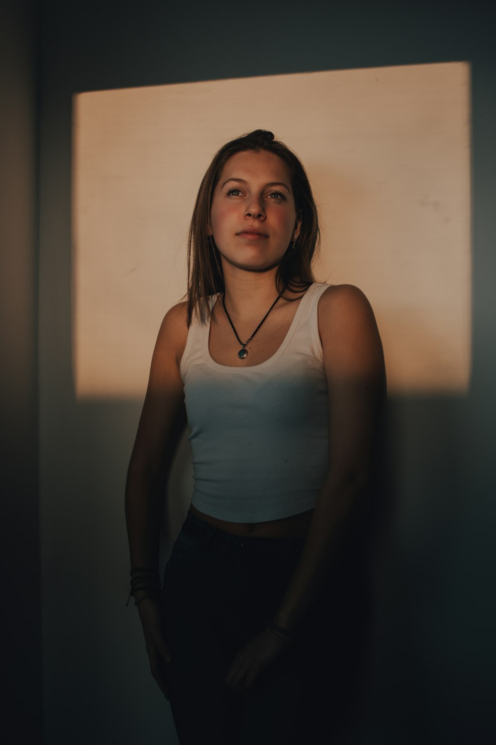 woman in white tank top and black pants