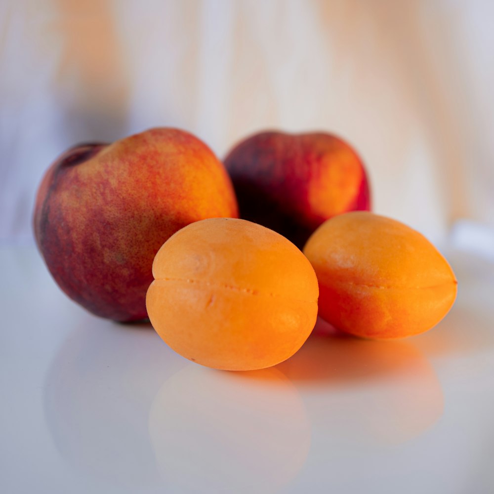 three round brown fruits on white surface