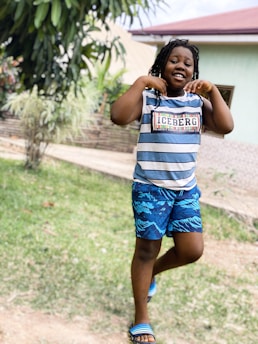 A happy child wearing a comfortable pants set playing outdoors