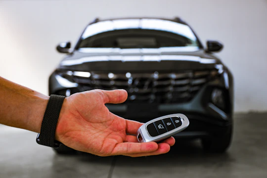 person holding black and silver audi car steering wheel
