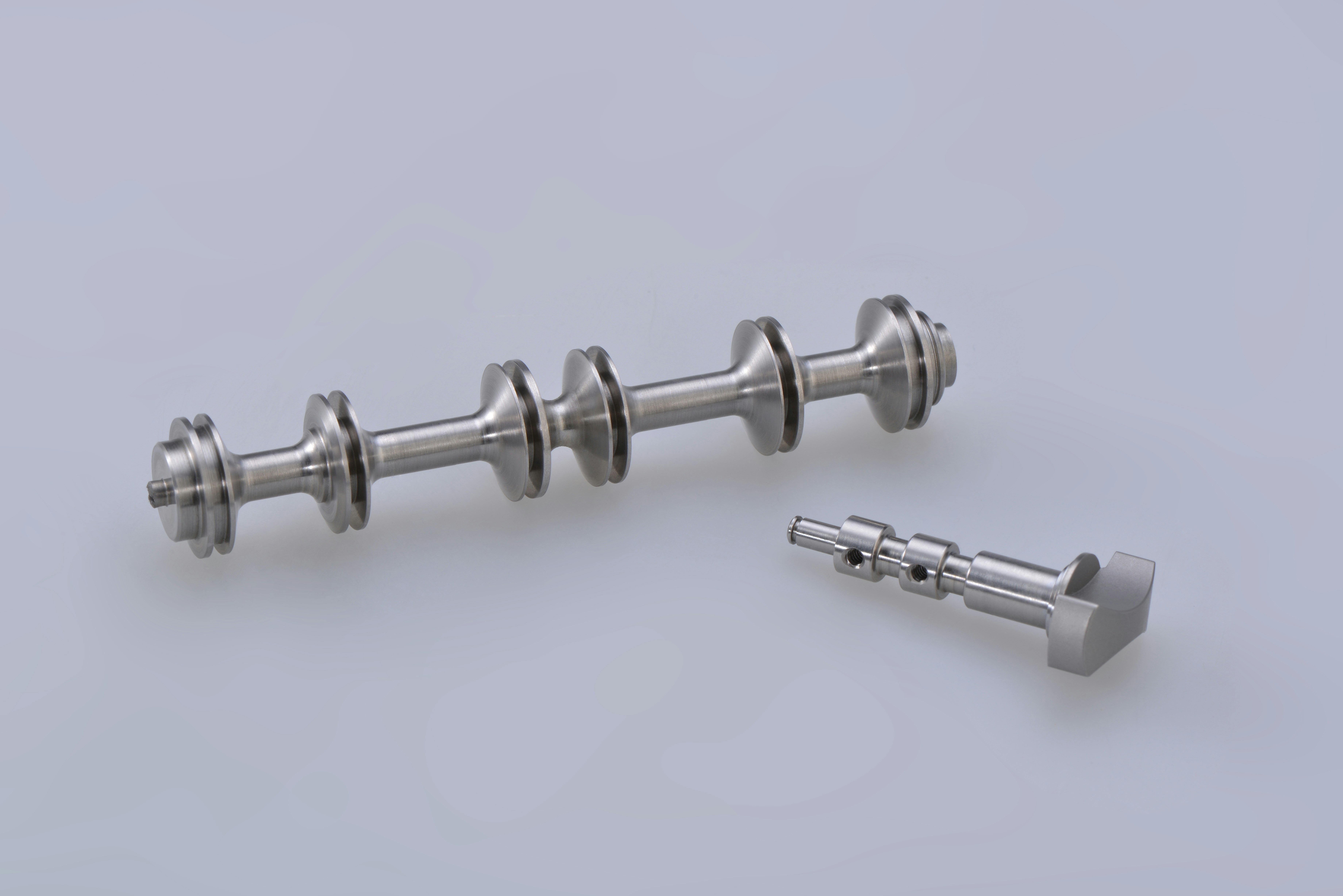 silver steel dumbbell on white surface