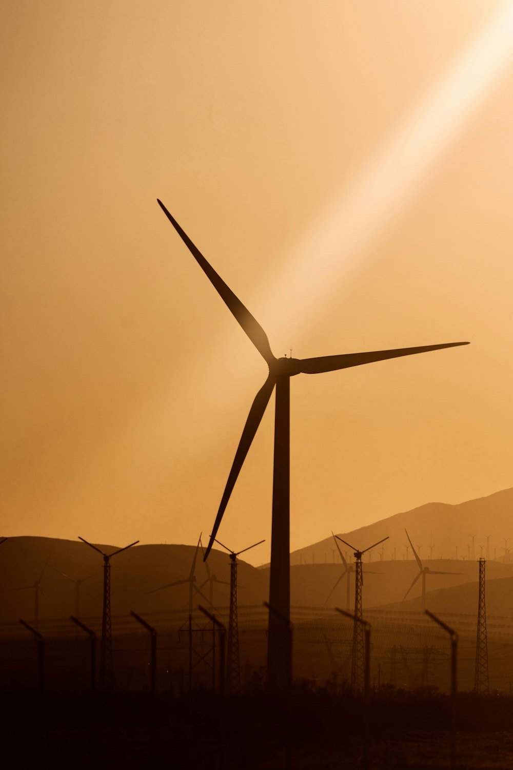 white wind turbine during daytime