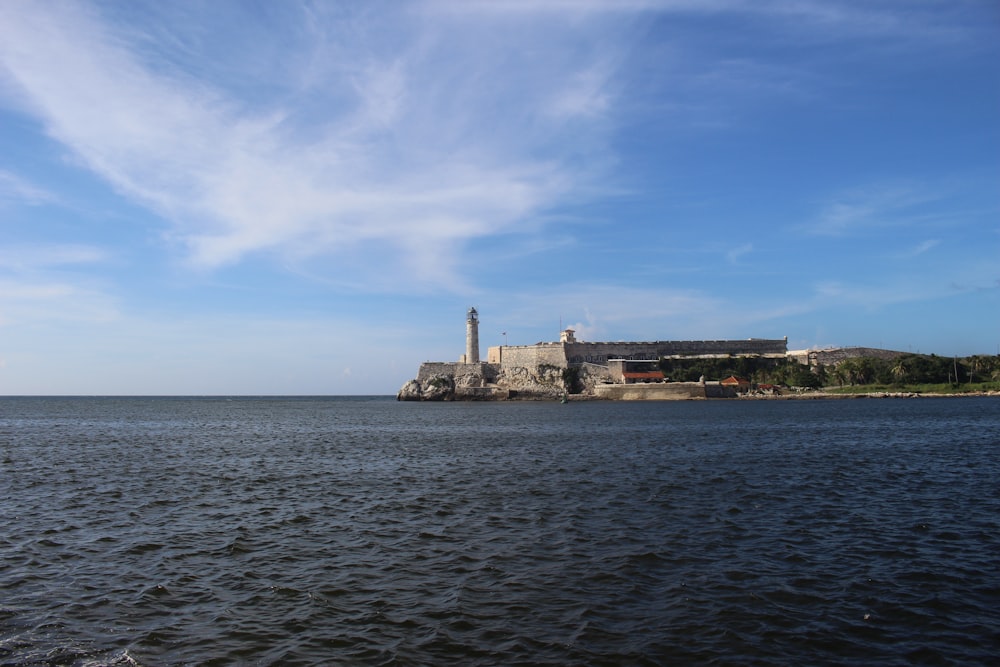 brown concrete building near body of water during daytime