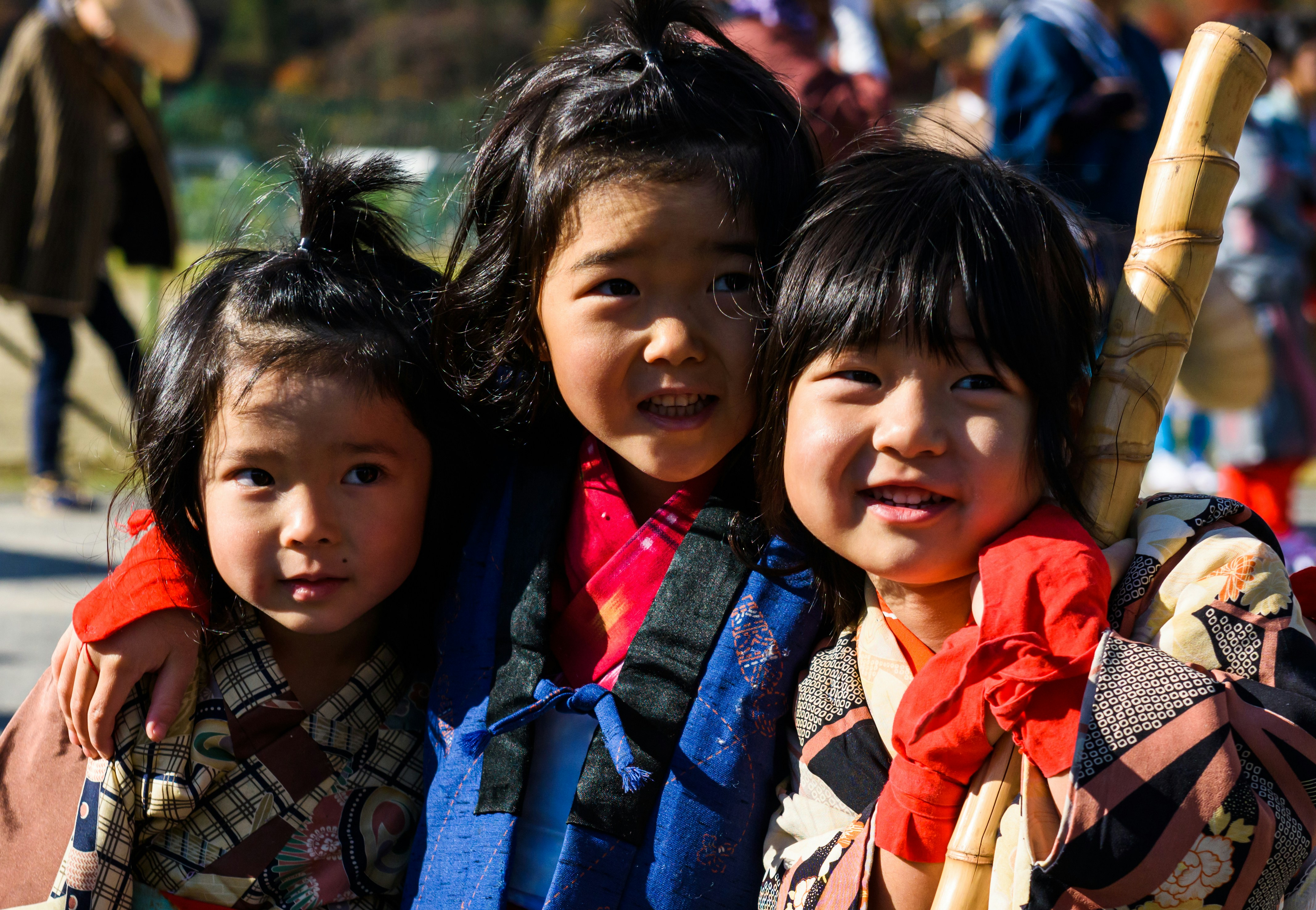 girl in blue and brown scarf smiling