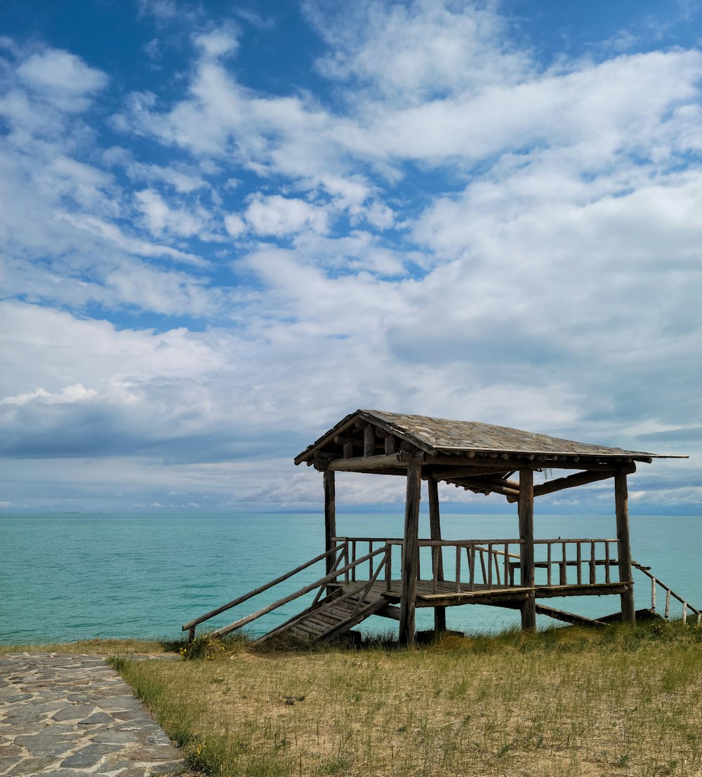 brown wooden house on seashore during daytime