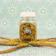 A joyful customer holding a jar of honey with a lush forest background.