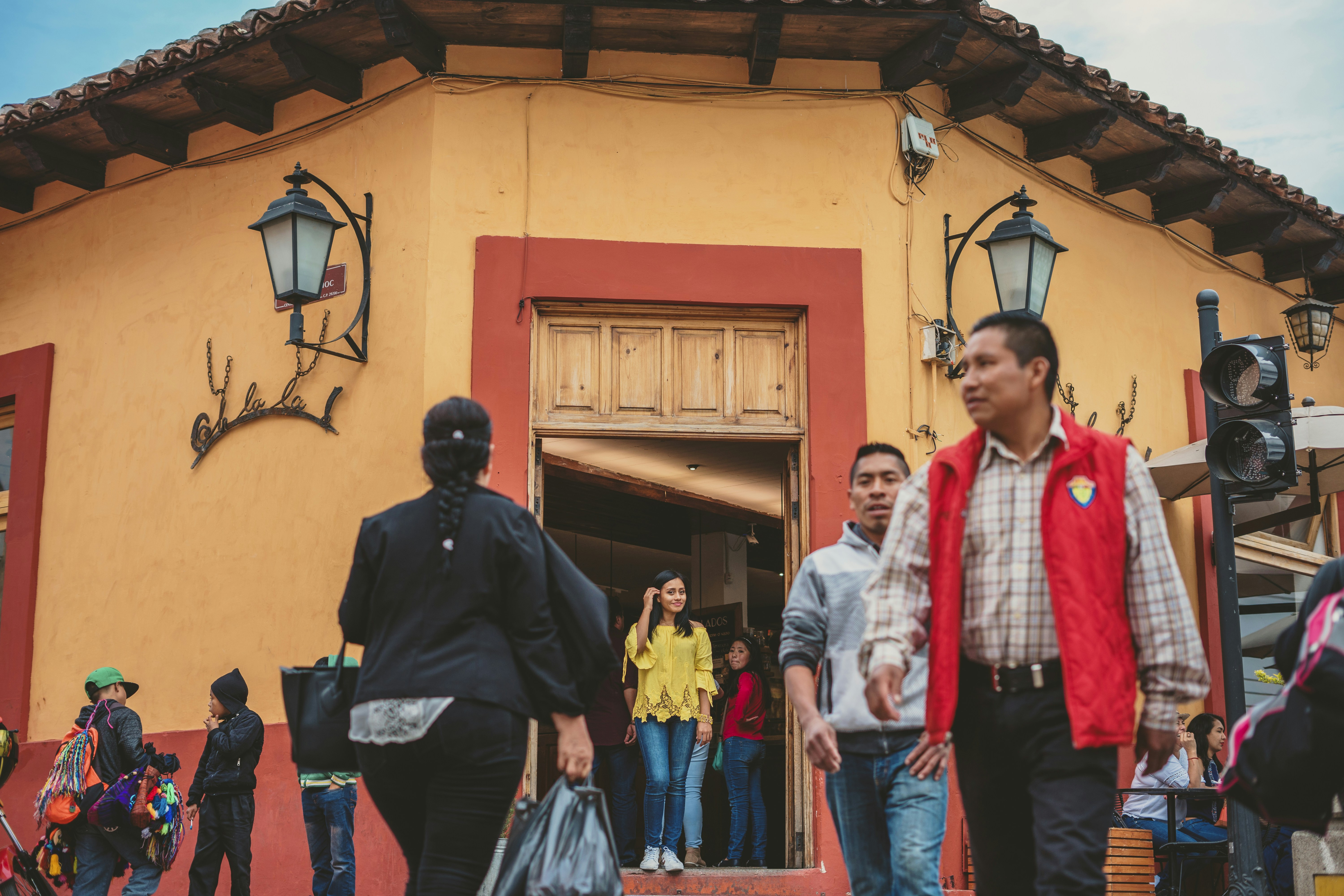 man in black jacket standing beside woman in white and red scarf