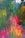 A vibrant and abstract watercolor painting featuring a mix of colors such as green, pink, yellow, and blue. The colors blend and flow into each other, creating an effect reminiscent of foliage or flowers. The image has a textured, almost fabric-like appearance with irregular shapes and vivid patches of color.