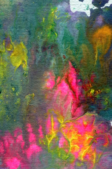 A vibrant and abstract watercolor painting featuring a mix of colors such as green, pink, yellow, and blue. The colors blend and flow into each other, creating an effect reminiscent of foliage or flowers. The image has a textured, almost fabric-like appearance with irregular shapes and vivid patches of color.