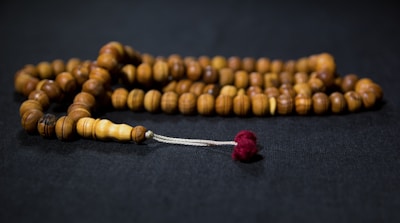 A collection of delicate prayer beads resting on a velvet cloth.