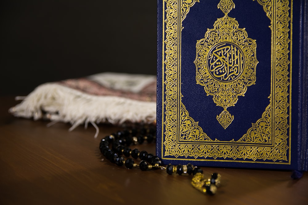 blue and gold book on white textile