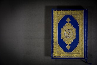 A beautifully designed book cover of 'Aazhikondan – The Conqueror of the Ocean' resting on a vintage map.