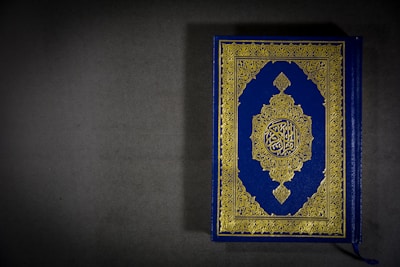 A beautifully designed book cover of 'Aazhikondan – The Conqueror of the Ocean' resting on a vintage map.