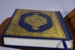 An elegant fancy Quran with a golden cover.
