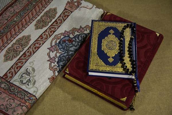 Beautiful prayer mat laid out with intricate embroidery and warm colors.