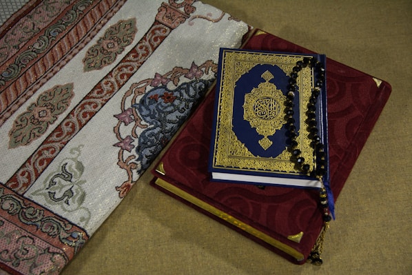 A close-up of a beautifully embroidered prayer mat with a custom name stitched in elegant script.