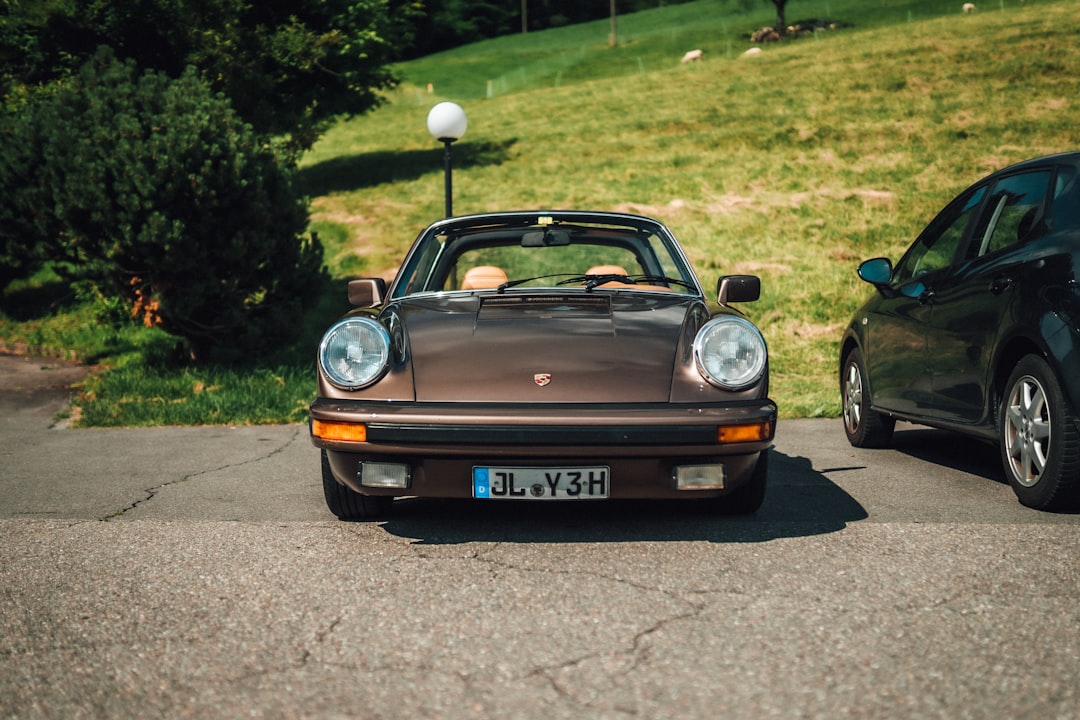 brown porsche 911 on road during daytime