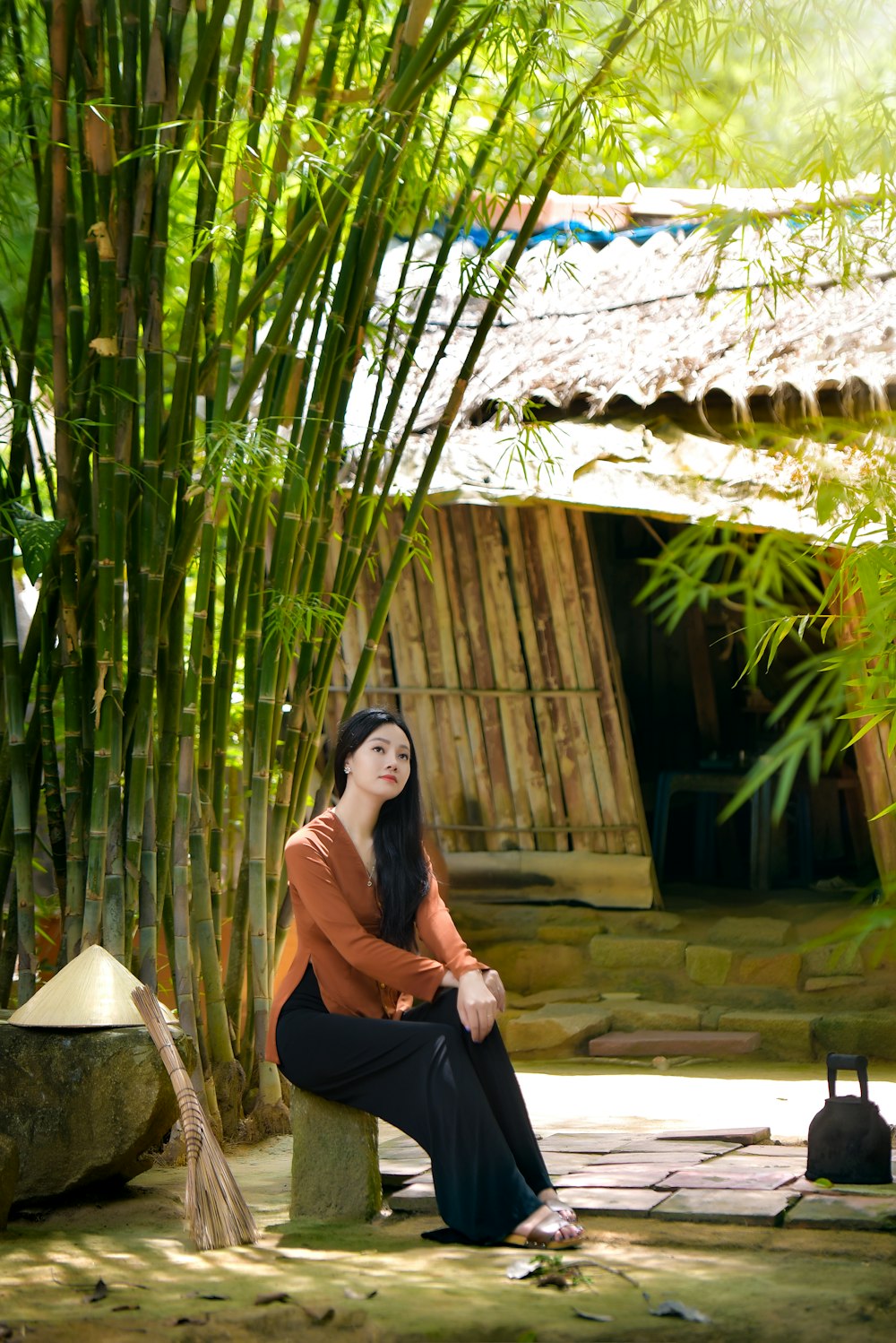 woman in black sleeveless dress sitting on brown wooden armchair