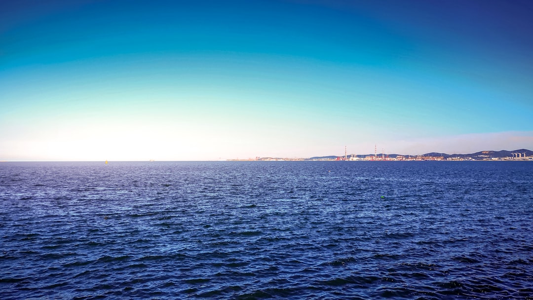 body of water under blue sky during daytime