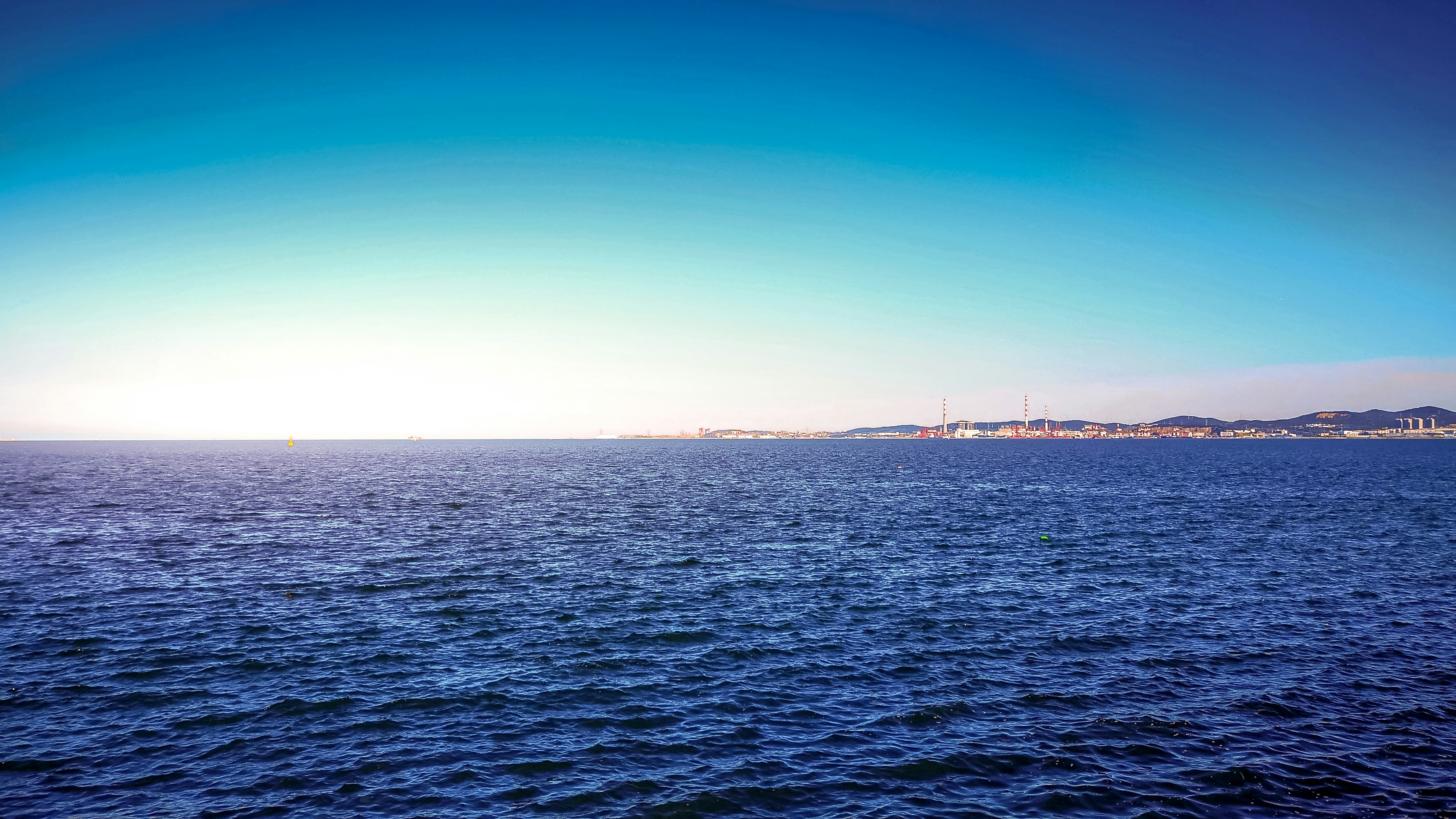 body of water under blue sky during daytime