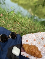 Waterproof blanket protecting a picnic area from damp grass on a sunny day.