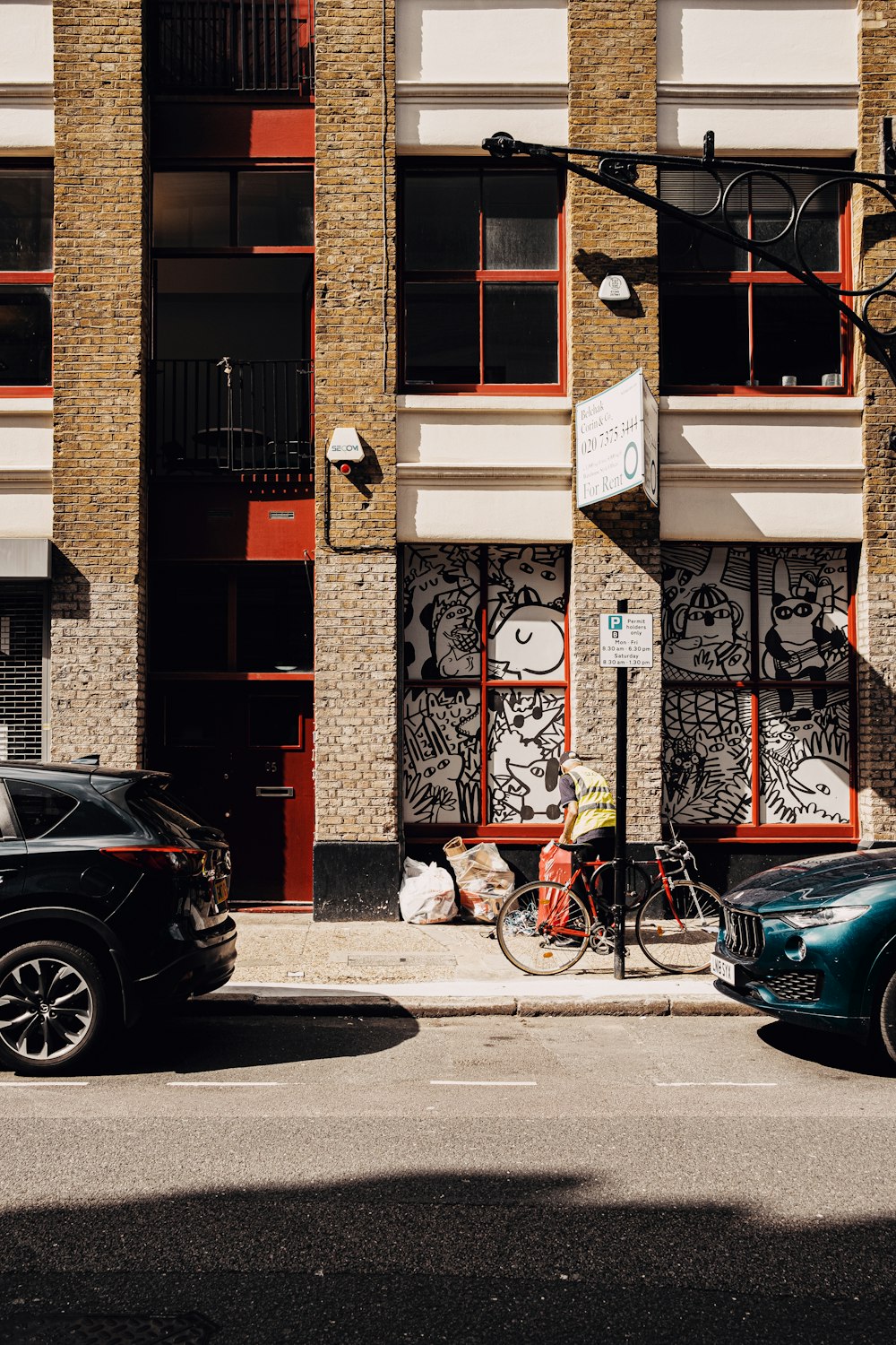 black bicycle parked beside black car