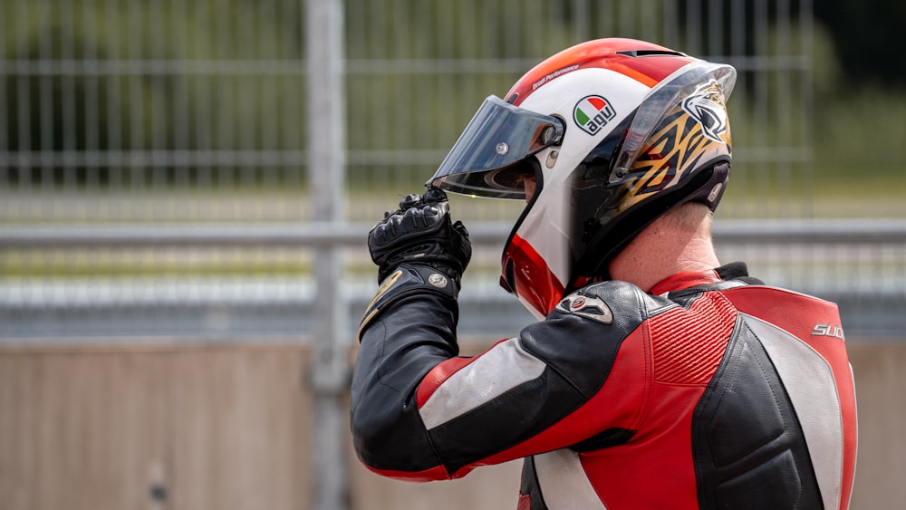 man in red and black helmet and black jacket