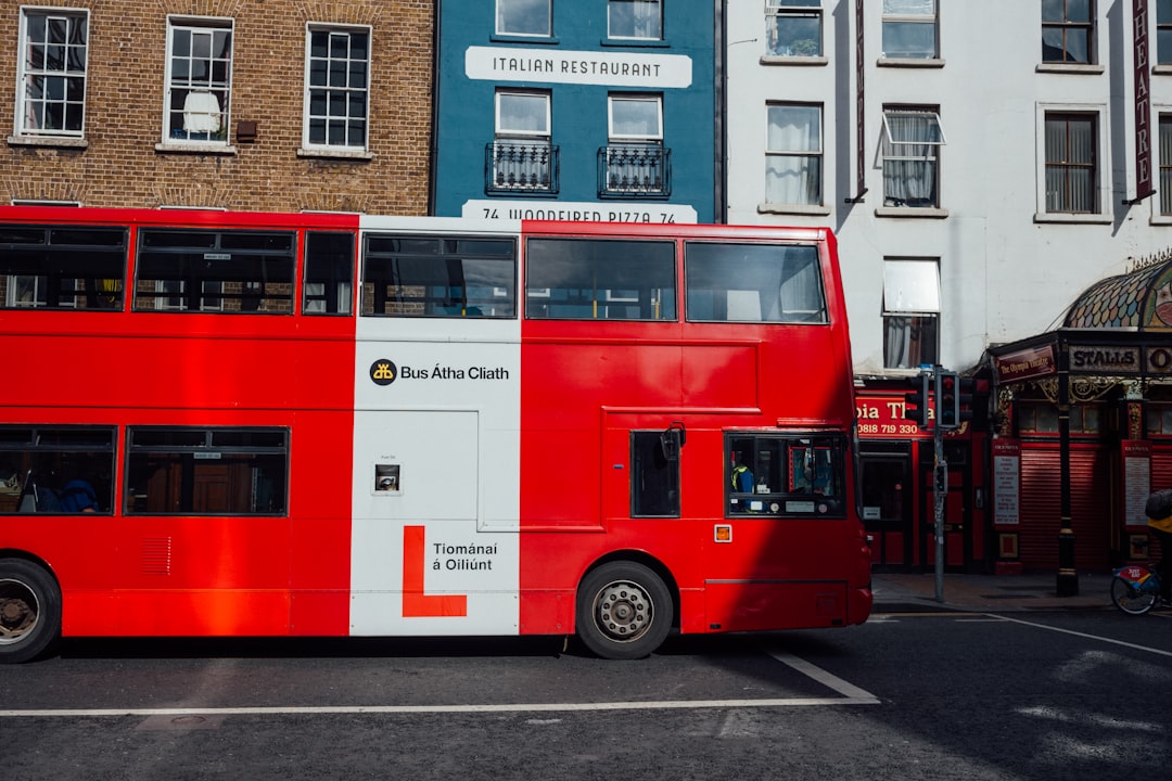 red double decker bus on road during daytime