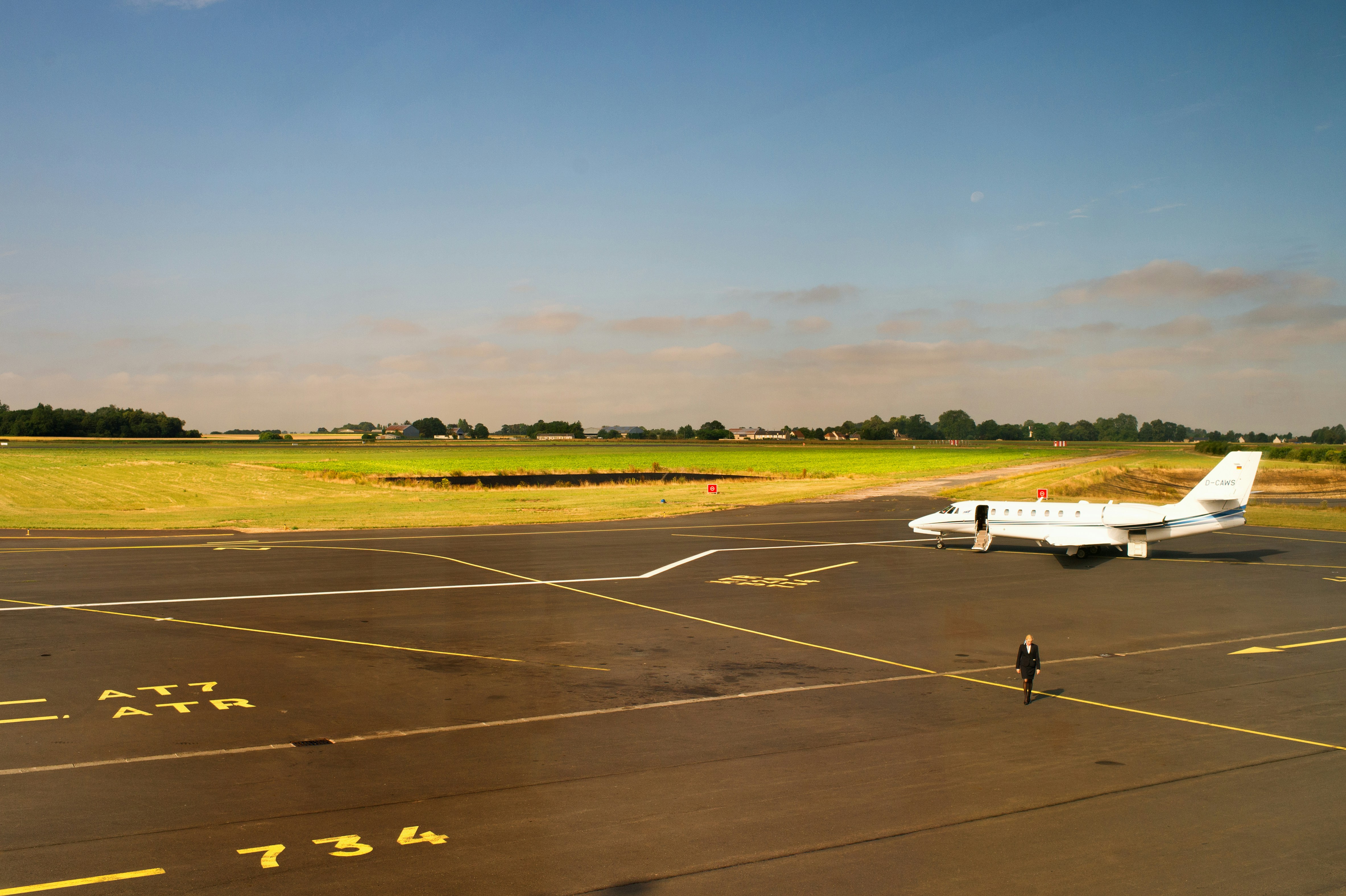 white passenger plane on airport during daytime, Cessna 680 is waiting at AT7at point 734 with Scarlett J. alias Lucy for searching Don Jon