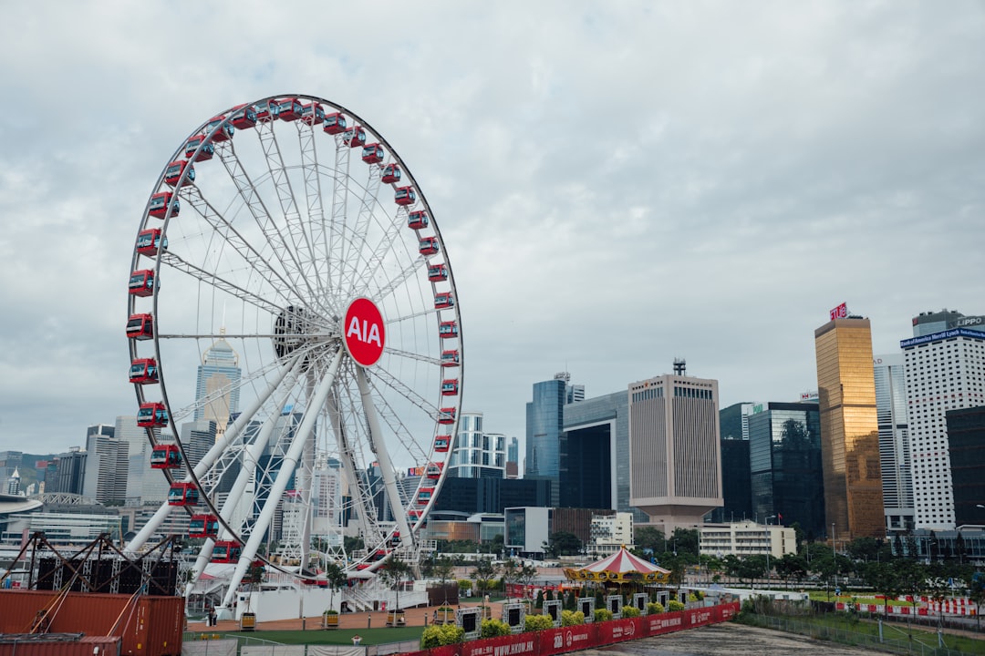 ferris wheel near city buildings during daytime