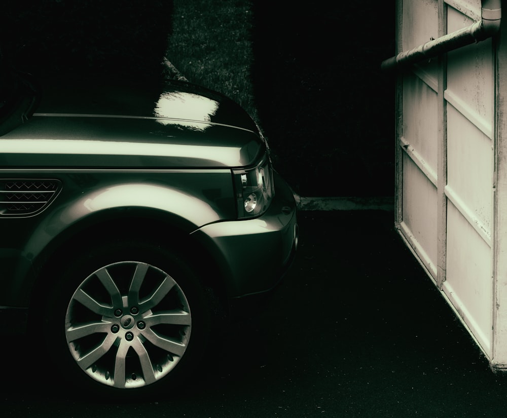 white car parked beside white garage door